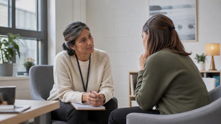 Colleagues discussing safeguarding and the Prevent duty.