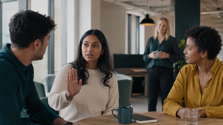 Colleagues discussing how to prevent sexual harassment at work.